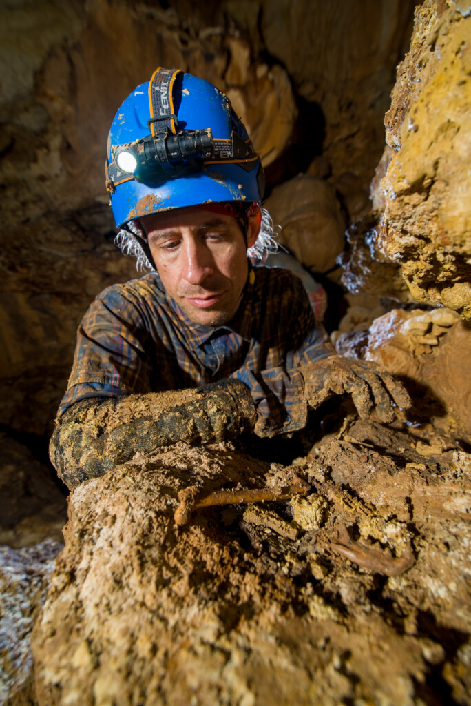 Paleontologist and bones in cave