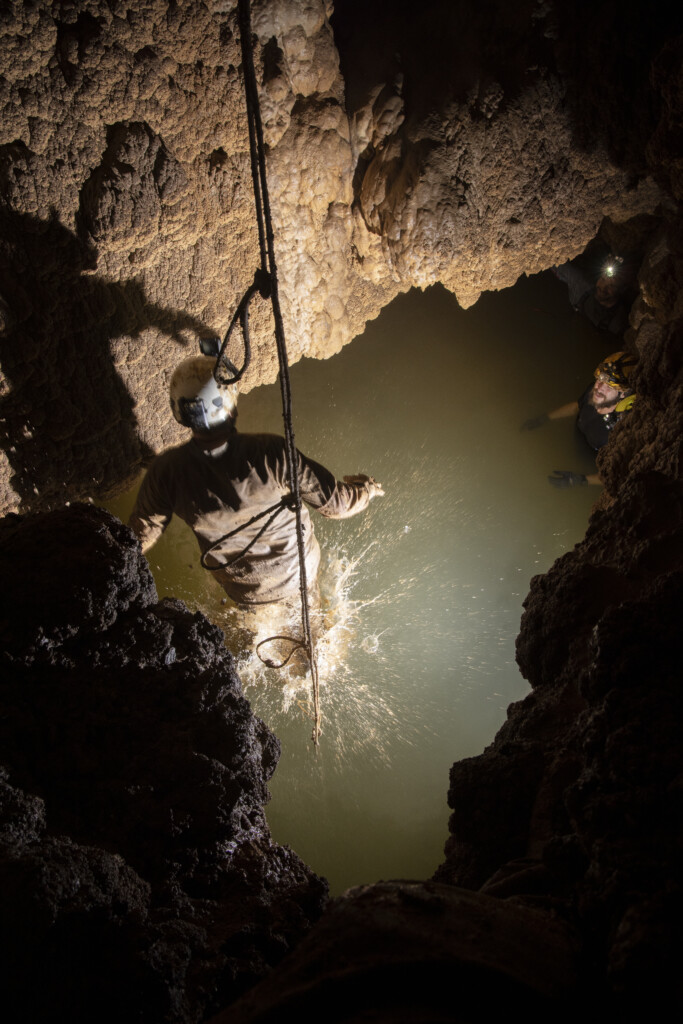 Caver descends into pool
